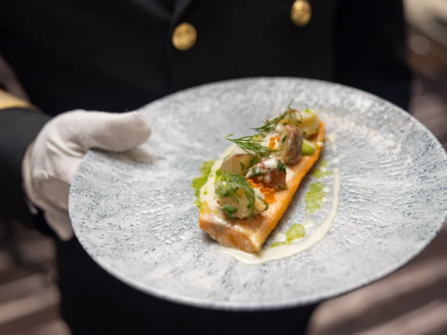Serving delicacies for guests in restaurant Røst on board